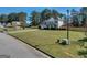 Well-maintained home featuring a lush lawn, a driveway, and a charming fence enhancing its curb appeal at 720 Strawflower Ln, Locust Grove, GA 30248