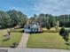 Beautiful home with lush lawn, mature trees, and a long driveway at 720 Strawflower Ln, Locust Grove, GA 30248