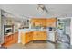 Bright eat-in kitchen features wooden cabinetry and views into the fireplace sitting room at 720 Strawflower Ln, Locust Grove, GA 30248