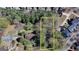 Aerial view of a wooded homesite in a residential community, surrounded by mature trees and established homes at 768 Scales Rd, Suwanee, GA 30024