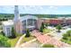 Striking aerial view of City Hall featuring a clock tower and an inviting park-like setting at 768 Scales Rd, Suwanee, GA 30024