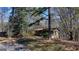 Exterior view of a cozy single-story home surrounded by mature trees and natural landscape at 768 Scales Rd, Suwanee, GA 30024