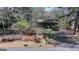 Charming single-story house featuring a cozy front porch and mature trees at 768 Scales Rd, Suwanee, GA 30024