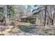 Charming single-story house featuring a cozy front porch, large yard and mature trees at 768 Scales Rd, Suwanee, GA 30024