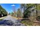 Neighborhood street view lined with mature trees and single-Gathering homes on a sunny day at 768 Scales Rd, Suwanee, GA 30024