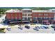 Aerial view showing the commercial spaces, apartments or condos, and parking area at 768 Scales Rd, Suwanee, GA 30024
