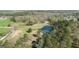 Expansive aerial view showcasing the large pond and surrounding trees of this private estate at 595 S Antioch Rd, Mcdonough, GA 30252