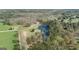 Scenic aerial view featuring a tranquil pond and beautiful trees enhancing the property's natural charm at 595 S Antioch Rd, Mcdonough, GA 30252