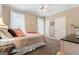 Cozy bedroom with plush carpet, natural light from the windows, and neutral paint, creating a relaxing atmosphere at 595 S Antioch Rd, Mcdonough, GA 30252