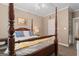 Comfortable bedroom with a carved four-poster bed and cozy decor at 595 S Antioch Rd, Mcdonough, GA 30252