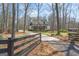 Long driveway leading up to a charming home with a black fence for added curb appeal at 595 S Antioch Rd, Mcdonough, GA 30252