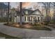 Elegant home with black shutters, rocking chair front porch, and mature landscaping at 595 S Antioch Rd, Mcdonough, GA 30252
