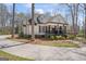 Elegant home with black shutters, rocking chair front porch, and mature landscaping at 595 S Antioch Rd, Mcdonough, GA 30252