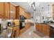 Well-lit kitchen boasts granite countertops, tile backsplash, and wood cabinets with modern appliances at 595 S Antioch Rd, Mcdonough, GA 30252