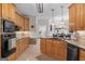 Spacious kitchen features granite countertops, wood cabinets, and stainless steel appliances with an island at 595 S Antioch Rd, Mcdonough, GA 30252