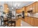 Charming kitchen with granite countertops, wood cabinets, black appliances, and a kitchen island at 595 S Antioch Rd, Mcdonough, GA 30252