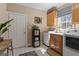 Functional laundry room equipped with wooden cabinets, white appliances, and plenty of storage space at 595 S Antioch Rd, Mcdonough, GA 30252