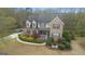 Aerial view of a well-maintained home with mature trees and a curved driveway at 308 Tussahaw Trl, Locust Grove, GA 30248