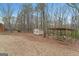 Spacious backyard featuring a storage shed, wooded area and a covered area for relaxing outdoors at 308 Tussahaw Trl, Locust Grove, GA 30248