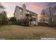 Backyard view of home showing deck and patio with lovely sunset skies at 308 Tussahaw Trl, Locust Grove, GA 30248