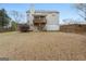 Backyard view of the home featuring a covered patio, multilevel deck, and lush lawn at 308 Tussahaw Trl, Locust Grove, GA 30248