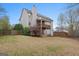 Backyard with a multilevel deck, and lush green lawn at 308 Tussahaw Trl, Locust Grove, GA 30248
