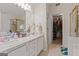 Bathroom features a double sink vanity, and a walk in closet, offering a luxurious spa-like experience at 308 Tussahaw Trl, Locust Grove, GA 30248