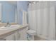 Bathroom featuring a toilet, shower with curtain, and a well-lit vanity, designed for convenience at 308 Tussahaw Trl, Locust Grove, GA 30248