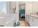 Bright bathroom showcases a soaking tub and an opening to the bedroom, creating a luxurious retreat at 308 Tussahaw Trl, Locust Grove, GA 30248