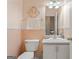 Functional half bathroom with white cabinetry and a decorative mirror at 308 Tussahaw Trl, Locust Grove, GA 30248