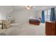 Spacious bedroom with neutral carpet, ceiling fan, and large windows providing lots of natural light at 308 Tussahaw Trl, Locust Grove, GA 30248
