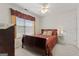 Comfortable bedroom featuring a ceiling fan and natural light from a window, creating a cozy atmosphere at 308 Tussahaw Trl, Locust Grove, GA 30248