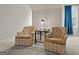 A close up of a comfortable seating area in the bedroom with two chairs and a small table at 308 Tussahaw Trl, Locust Grove, GA 30248