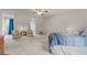 Bright bedroom with two seating areas, lots of natural light, neutral carpet, and ceiling fan at 308 Tussahaw Trl, Locust Grove, GA 30248