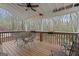 Enjoy this shaded deck with a ceiling fan and wooded views at 308 Tussahaw Trl, Locust Grove, GA 30248