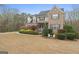 Stately brick fronted home with a manicured lawn and garden at 308 Tussahaw Trl, Locust Grove, GA 30248