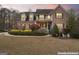 Charming two-story brick home with manicured landscaping and a cozy front porch at 308 Tussahaw Trl, Locust Grove, GA 30248