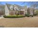 Charming brick front home with blue shutters, complemented by lush landscaping at 308 Tussahaw Trl, Locust Grove, GA 30248