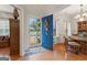 Inviting foyer with a blue front door, hardwood floors, and a view into the dining room at 308 Tussahaw Trl, Locust Grove, GA 30248