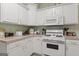 Efficient kitchen with white cabinets, offering functionality and easy access to essential appliances at 308 Tussahaw Trl, Locust Grove, GA 30248