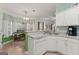 Well-lit kitchen featuring a breakfast nook, white appliances and cabinets with easy access to the dining area at 308 Tussahaw Trl, Locust Grove, GA 30248