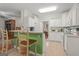 Bright kitchen with white cabinets and an open layout flows seamlessly to the breakfast area at 308 Tussahaw Trl, Locust Grove, GA 30248