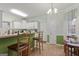 Charming kitchen with white cabinets, and a breakfast bar that offers casual dining space at 308 Tussahaw Trl, Locust Grove, GA 30248