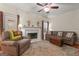 Cozy living room with plush seating, fireplace, and ceiling fan for comfortable living at 308 Tussahaw Trl, Locust Grove, GA 30248