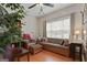 Cozy living room with natural light, a comfortable sofa, and built-in bookshelves at 308 Tussahaw Trl, Locust Grove, GA 30248