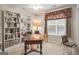 Inviting home office features built-in bookshelves, a large window, and ample natural light at 308 Tussahaw Trl, Locust Grove, GA 30248