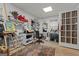 Bright office space with an easel, computer, shelving and a beautiful rug at 308 Tussahaw Trl, Locust Grove, GA 30248