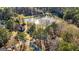 Scenic aerial perspective capturing a home surrounded by lush greenery and a picturesque lake at 171 Rockspray Rdg, Peachtree City, GA 30269
