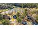 Stunning aerial view of a home nestled within a wooded community near a serene lake at 171 Rockspray Rdg, Peachtree City, GA 30269