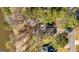 An aerial view of a home surrounded by mature trees, near the water, showcasing its private, natural setting at 171 Rockspray Rdg, Peachtree City, GA 30269